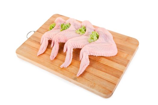 Raw chicken wings with green salad, isolated on white background, clipping path included 