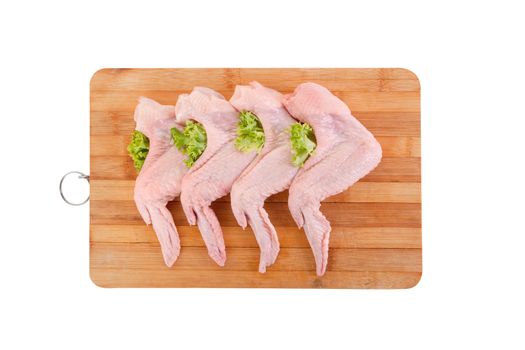 Raw chicken wings with green salad, high angle view, clipping path included 