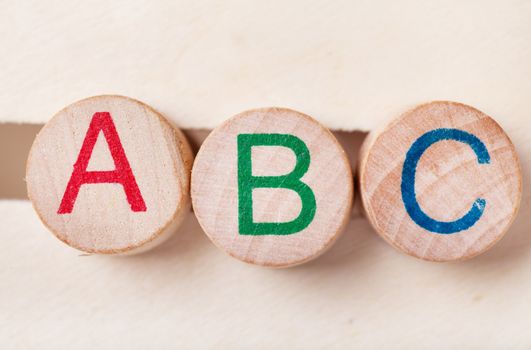 Three alphabet wooden blocks