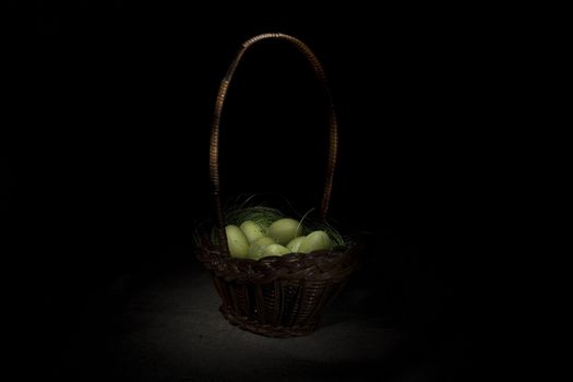 Easter basket on canvas background, effect of glowing in darkness 