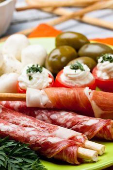 appetizers with salami,ham,tomato and olives
