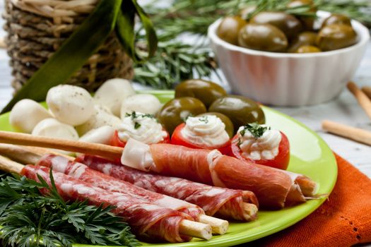 appetizers with salami,ham,tomato and olives