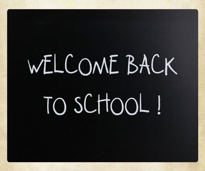 "Welcome back to school" handwritten with white chalk on a blackboard