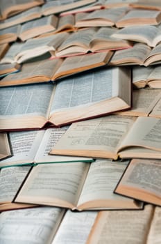 Many books laying and making pattern with shadows