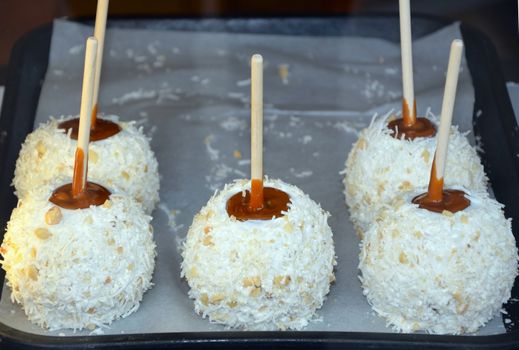 Coconut candy apples on display at market