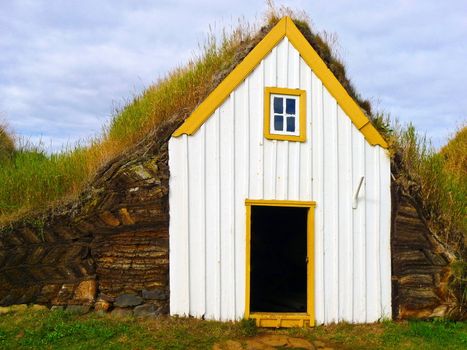 Traditional Yellow Iceland turfed roof house with green grass