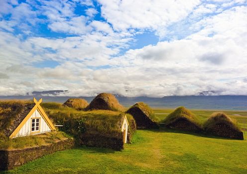 Traditional Yellow Iceland turfed roof housing with green grass