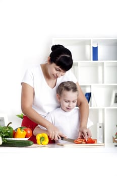 Mother and daughter cooking vegetable salad together