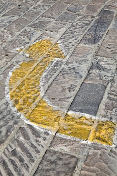 portrait of hand painted direction arrows on cobbled stone, sharp right left, 4 of 4