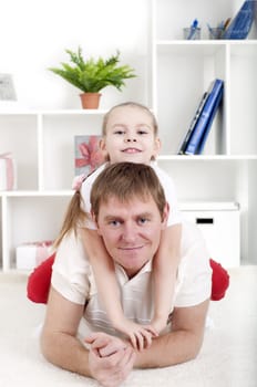 Portrait of happy family lying together, hugging and happy