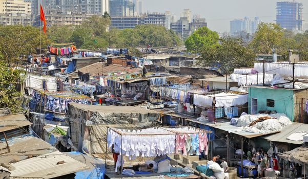 landscape of Dhobhi Ghat Mumbai, India with orange flag flying in the breeze