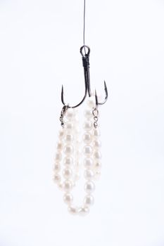 jewelry made of pearls hanging on fishing hook. not isolated