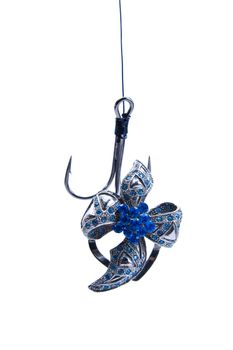 jewelry hanging on a fishing hook. isolated