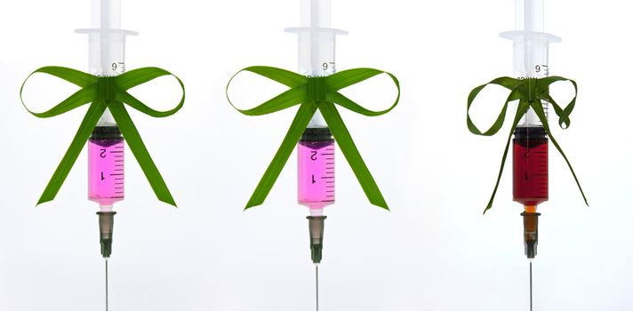 syringe with a pink liquid with a ribbon of grass with a vignette