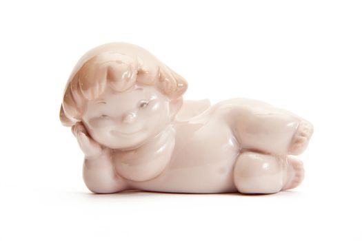 figurine of an angel pink lies on a white background. isolated