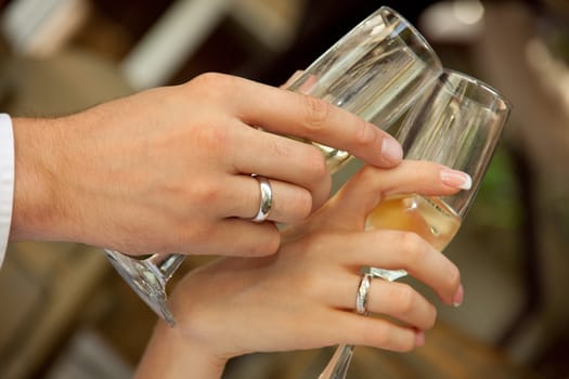 bride and groom with champagne glasses clink