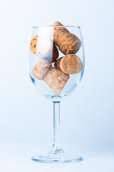 single glass wine with a corks of bottle on white background