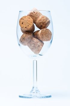 single glass wine with a corks of bottle on white background