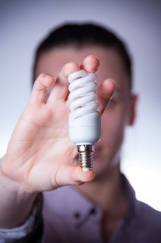 person holding energy saving lamp with vingette