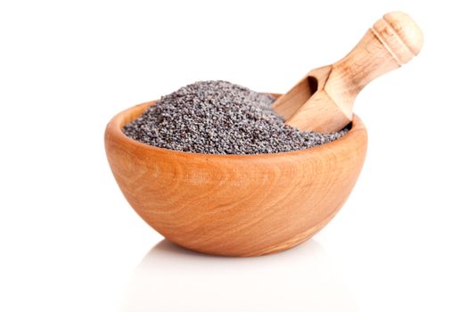 poppyseed in the wooden bowl with spoon, on a white background