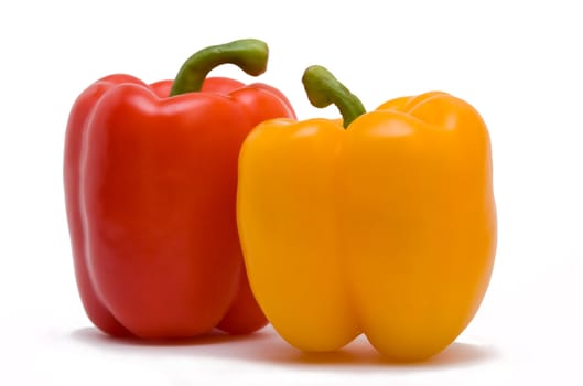 sweet red and yellow peppers isolated on white