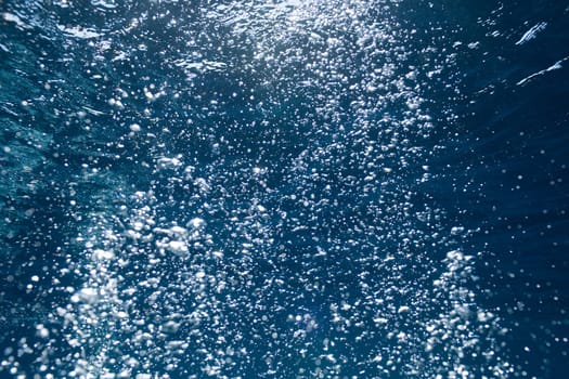 background of sunlight bubbles in deep water