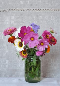 Bouquet garden flowers on the background of an old linen canvas. August, the Central Russia