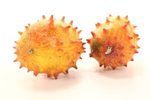 fresh raw orange Kiwano on a light background