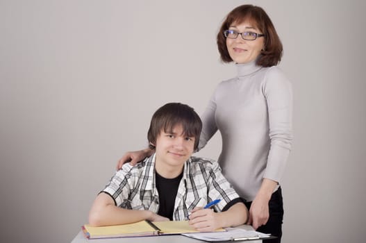 mother and son are together and smile in studio