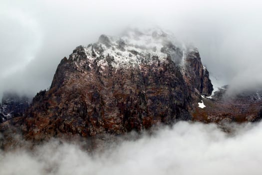 Dense clouds obscure jagged peaks of the Teton Range in western Wyoming