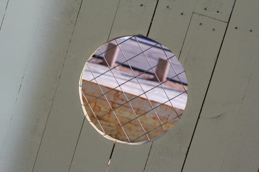 Peephole in a security fence at a construction site.