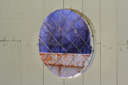 Peephole in a security fence at a construction site.