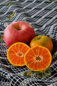 Apple and orange on fabric, Still life