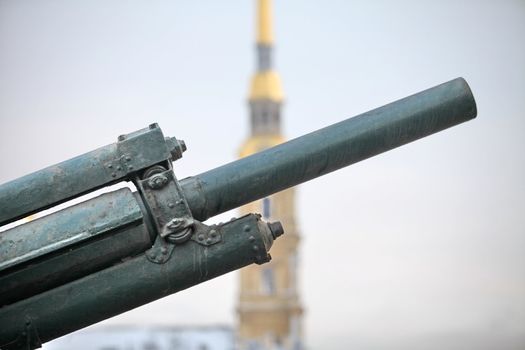 cannon barrel against the backdrop of a high bell tower