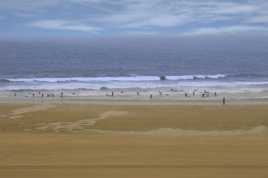 golden beach with children getting ready to be taught surfing in ballybunion county Kerry Ireland