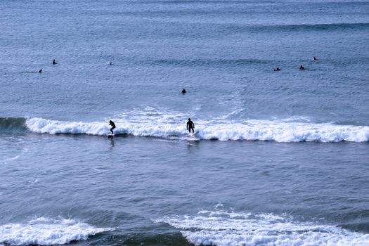 beautiful clean atlantic ocean with surfers catching the waves on Irelands coast