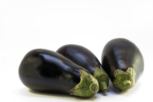 three eggplant on white