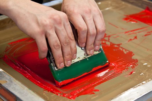 red color is printing on t-shirt with hands pressure