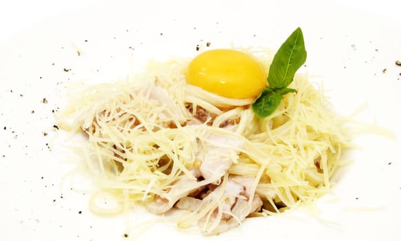 spaghetti with egg and greens on a white plate