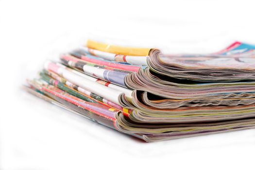 a stack of old magazines on white background