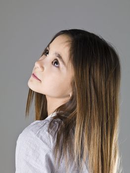 Portrait of a young girl on grey background