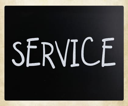 "Service" handwritten with white chalk on a blackboard