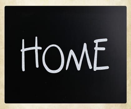 "Home" handwritten with white chalk on a blackboard