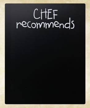 "Chef recommends" handwritten with white chalk on a blackboard