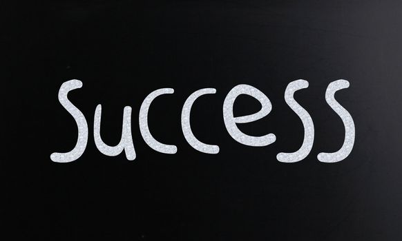 The word "Success" handwritten with white chalk on a blackboard