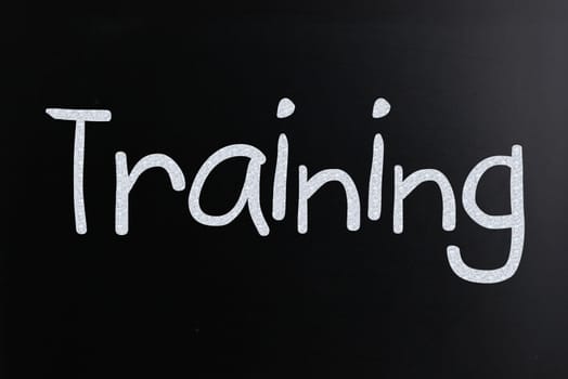 The word "Training" handwritten with white chalk on a blackboard