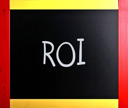 The word "ROI" handwritten with white chalk on a blackboard