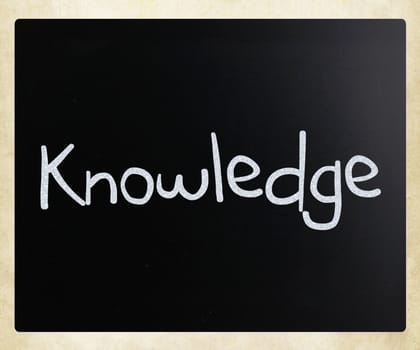 "Knowledge" handwritten with white chalk on a blackboard