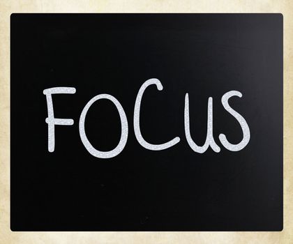 The word "Focus" handwritten with white chalk on a blackboard