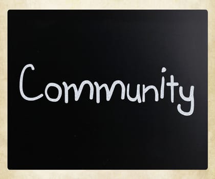 "Community" handwritten with white chalk on a blackboard